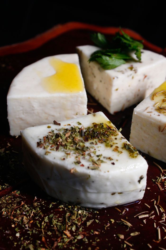 Rich, flavorful Brazilian cheese pieces garnished with fresh herbs and infused oils.